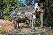 Angkor - Eastern Mebon - monolithic elephants at the corners of the platforms of the pyramid